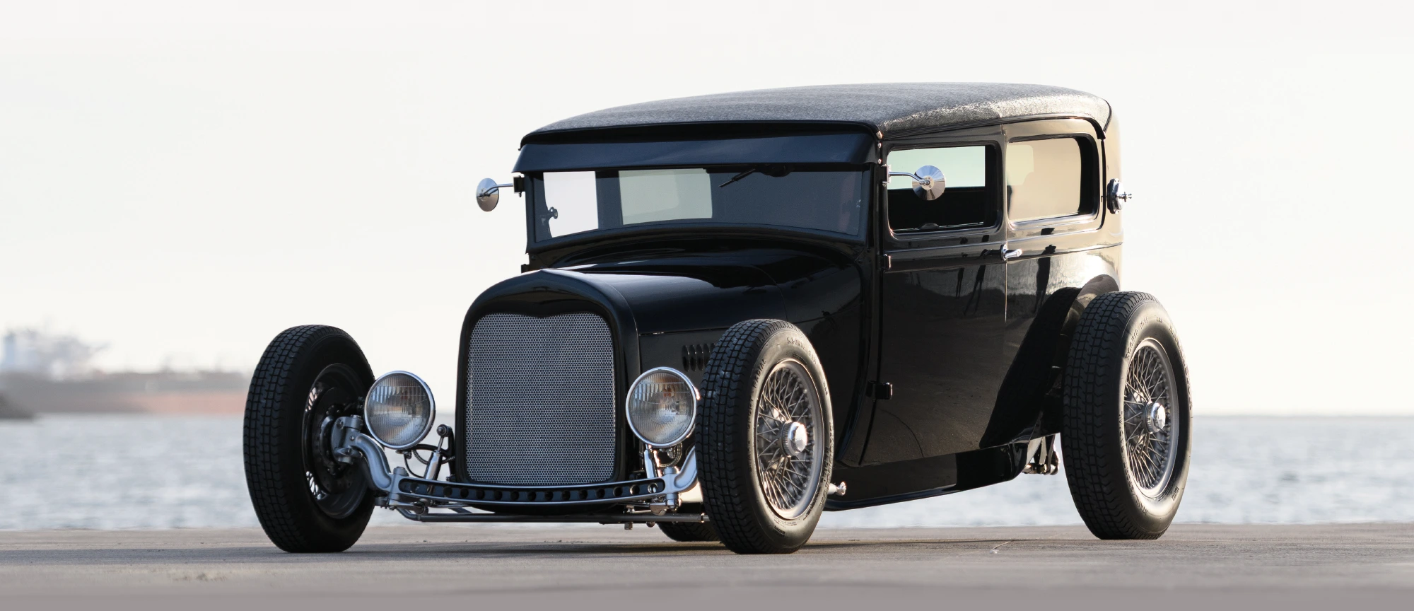 1929 Ford Tudor front end with custom grille, hairpin radius rods, and chrome shocks