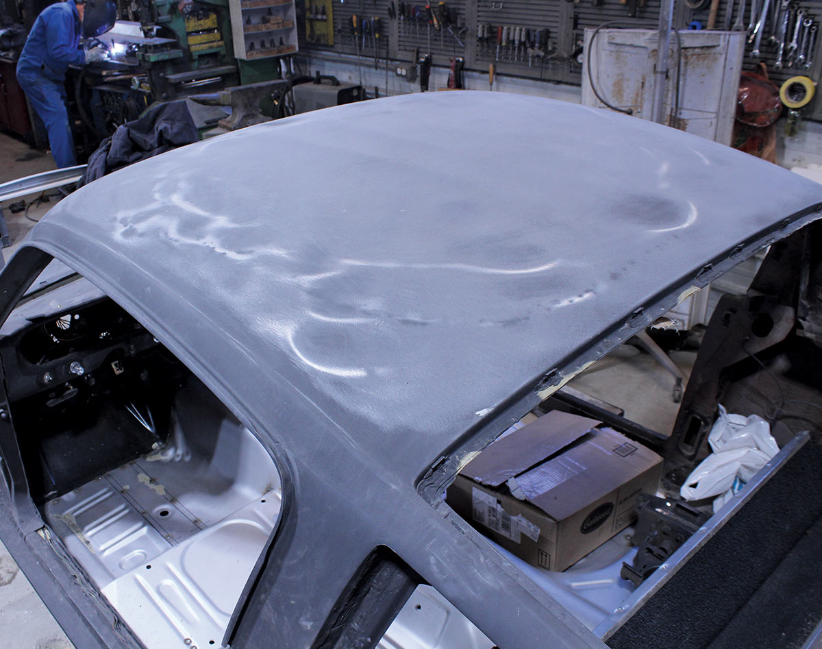 Damaged roof panel on the '65 Fastback shows dents and warping before removal