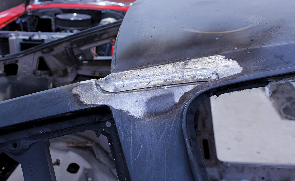 Exposed seam along the roof-to-A-pillar joint after grinding back filler and lead
