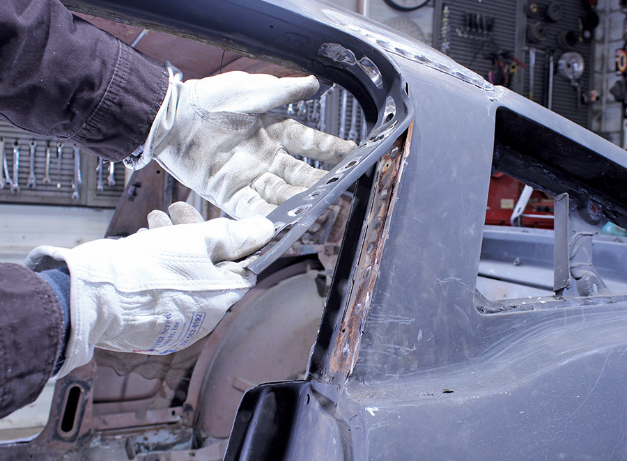 Rusted drip rail trim is removed from the 1965 Mustang Fastback A-pillar channel