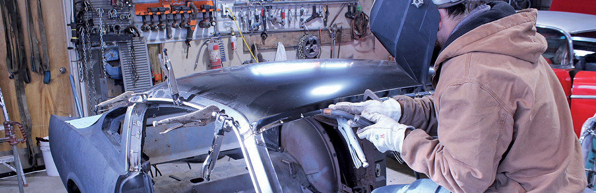 Replacement roof panel tack-welded in place with panel clamps for accurate fitment