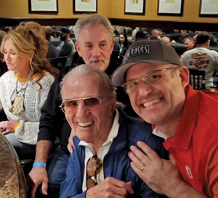 Angelo posing happily with Troy Trepanier, Alloway, and Cindy at an event