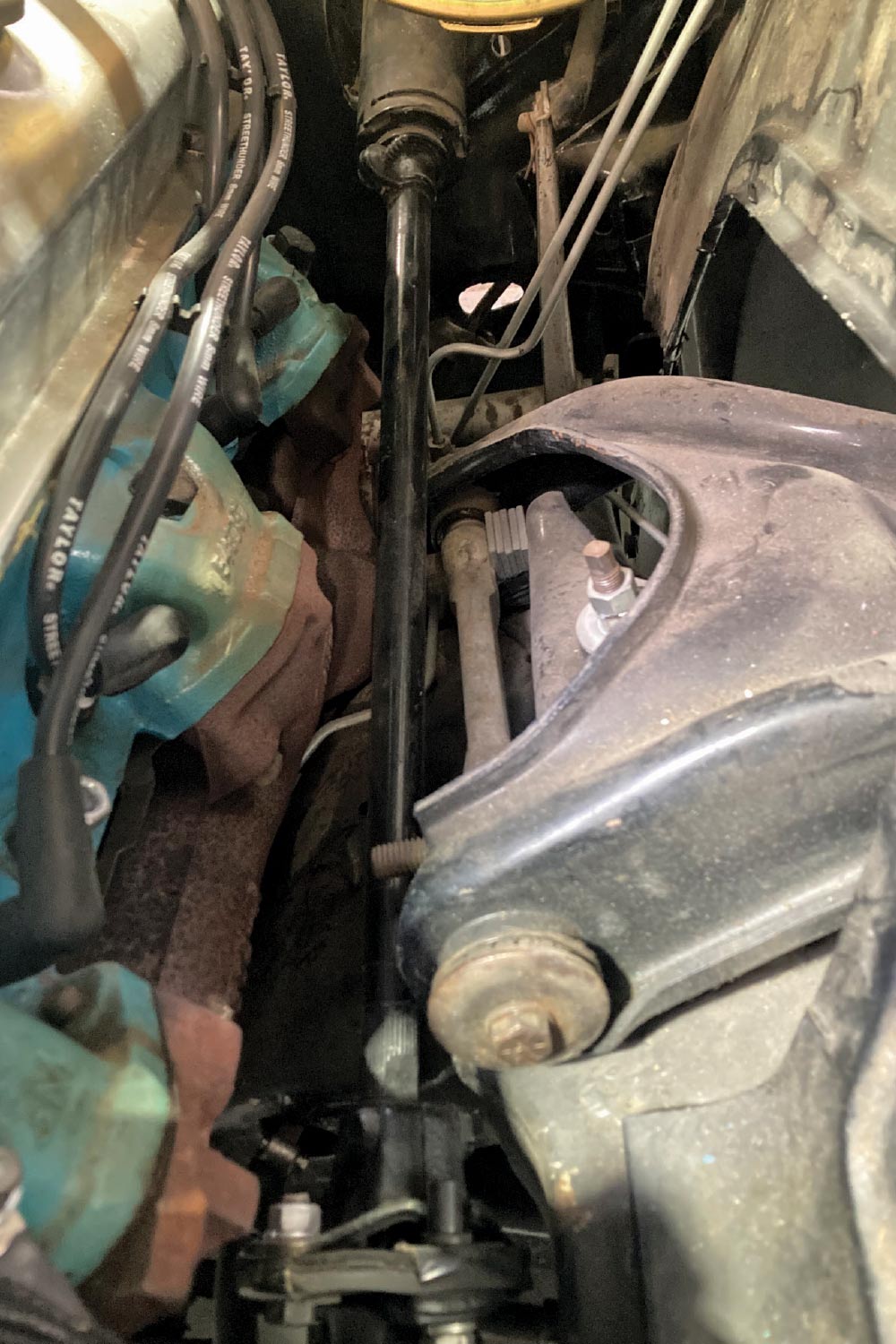 1964 Pontiac GTO steering shaft routing past headers and upper control arm with tight engine bay clearance