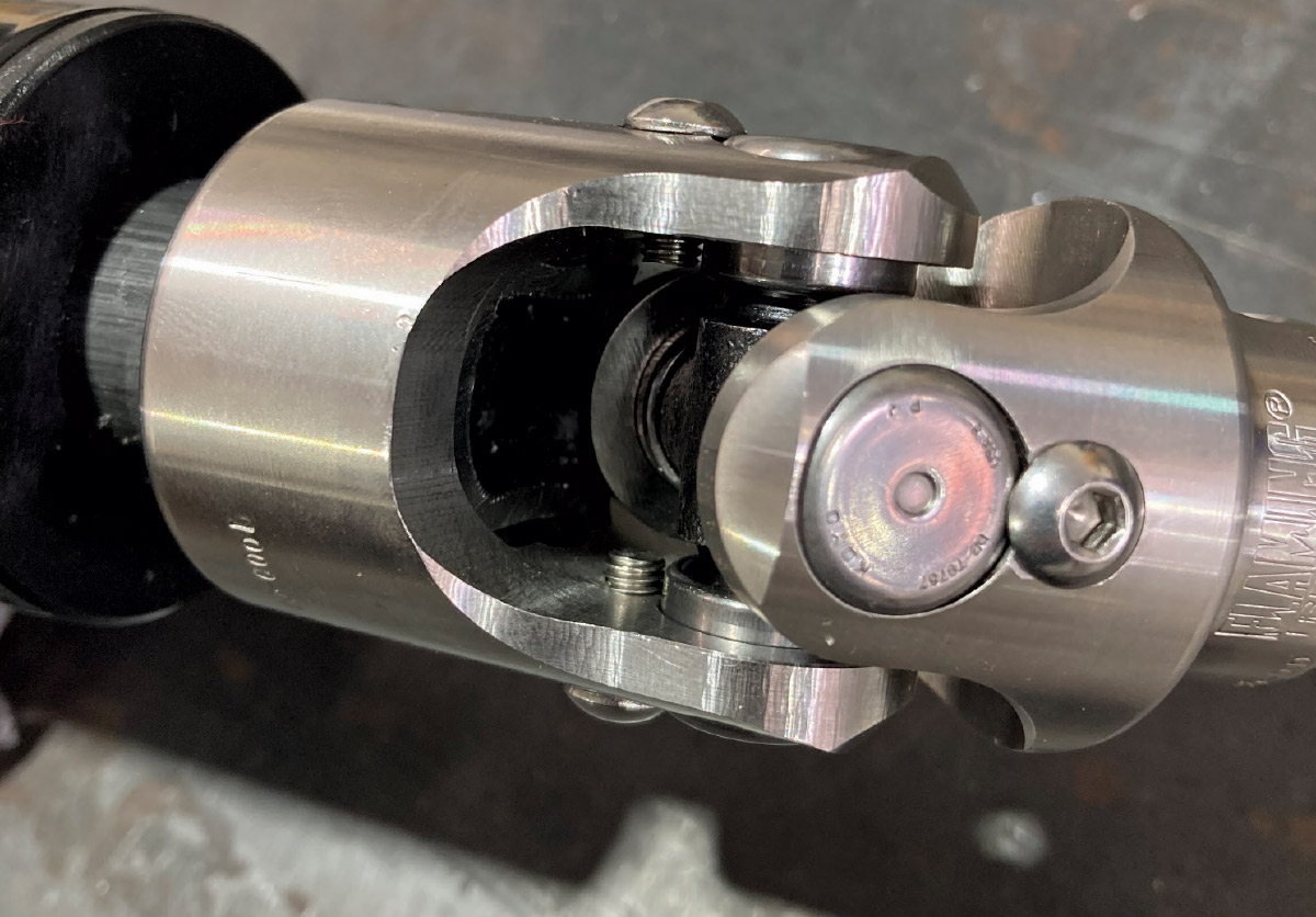 1964 Pontiac GTO polished U-joint close-up showing full spline engagement and safety fasteners