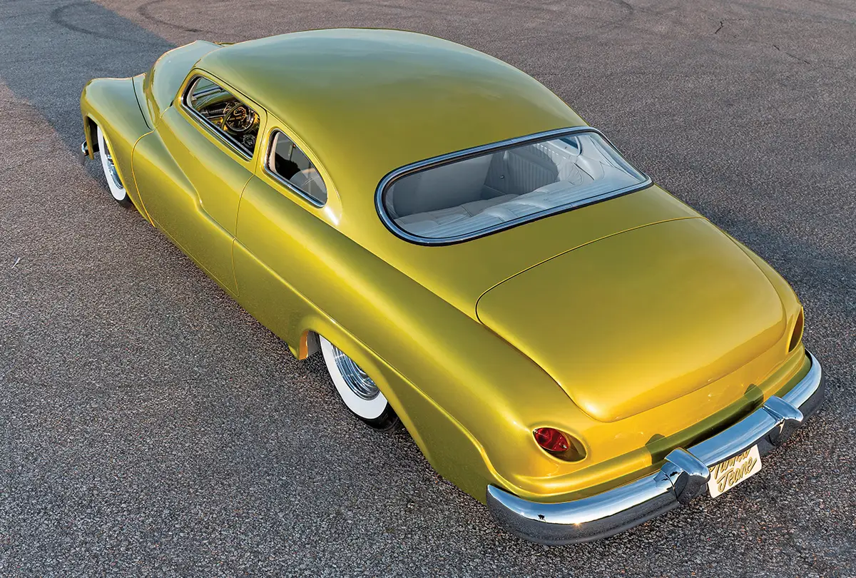 A top-down rear view of a custom yellow 1950 Mercury.