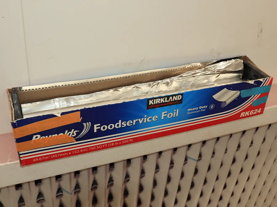 Kirkland heavy-duty aluminum foil roll used for masking during paint process