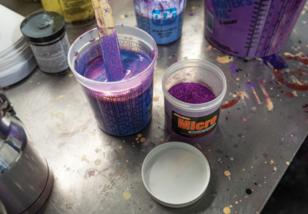Stirring metallic purple flake in PPG paint cup for custom hot rod application
