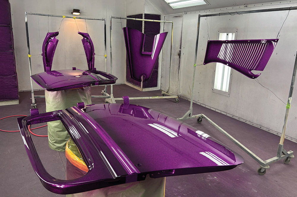 Classic Ford hot rod body panels drying after metallic purple flake paint application