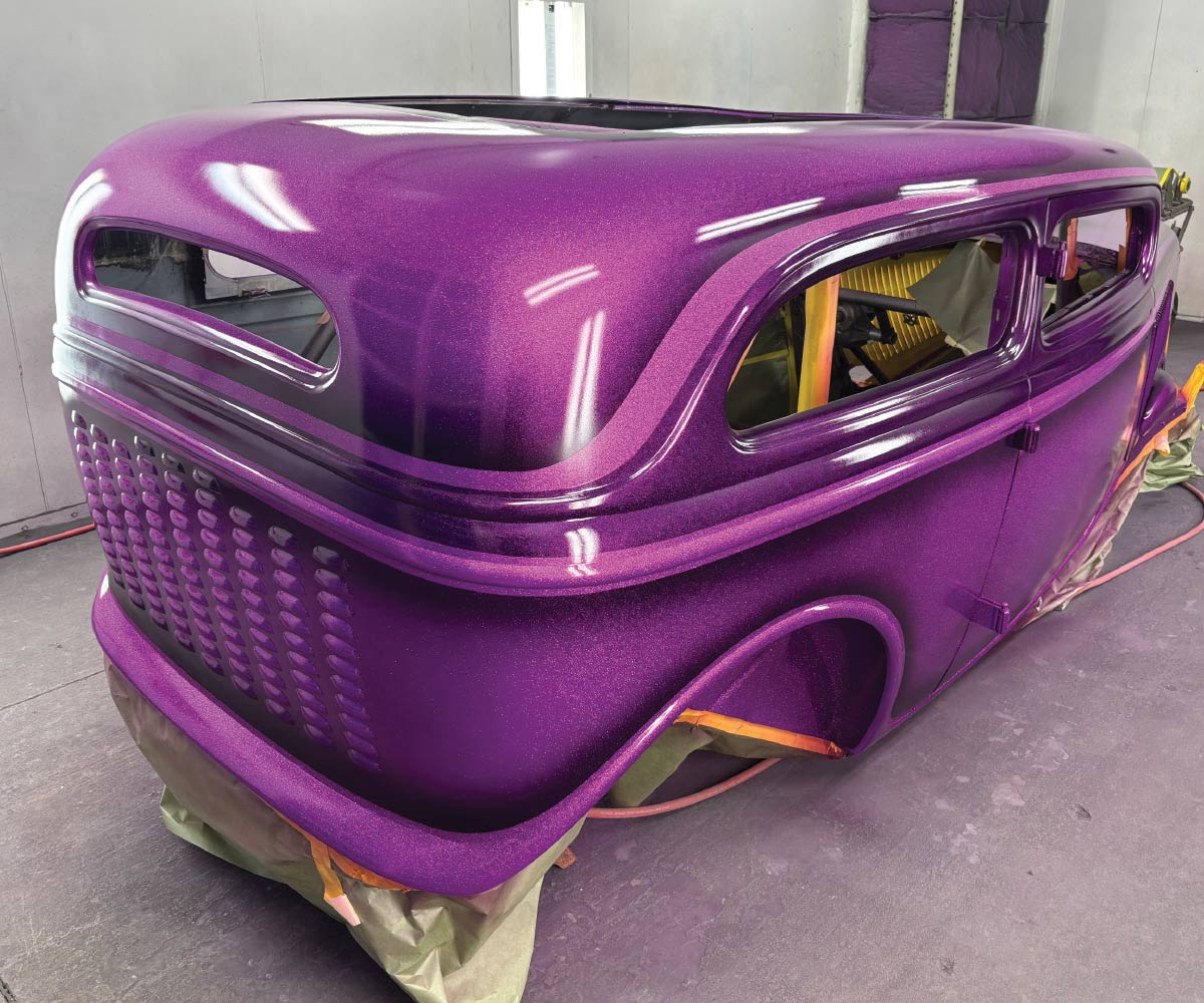 Rear view of 1934 Ford sedan hot rod with deep metallic purple flake paint
