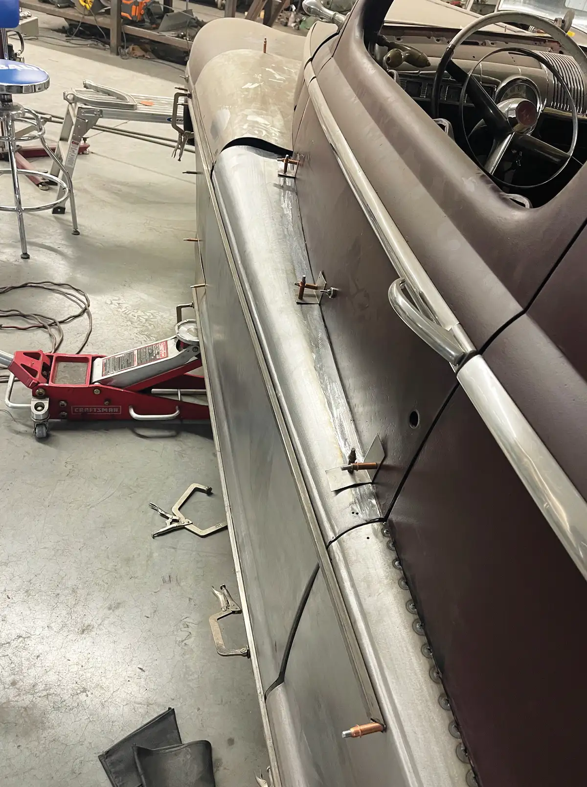 1947 Ford coupe close-up, fadeaway fender attached with cleco fasteners, door open