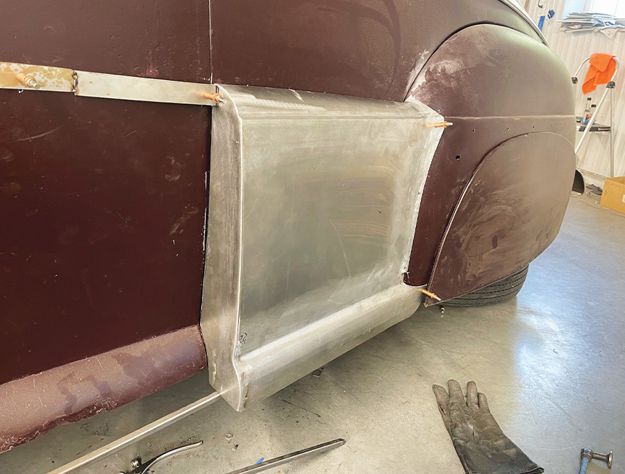 1947 Ford coupe rear fadeaway fender after shaping, cleco fasteners, workshop background