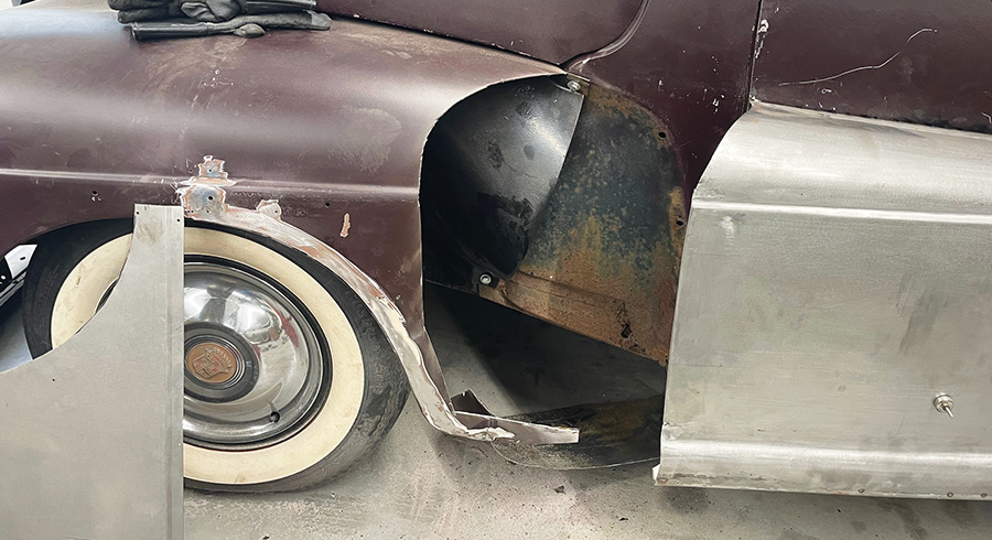 1947 Ford coupe front fender area exposed, gloves on hood, bare metal fadeaway fender panel