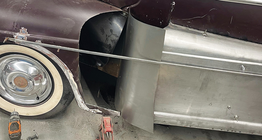 1947 Ford coupe, fadeaway fender mockup with vertical panel, drill and jack on shop floor