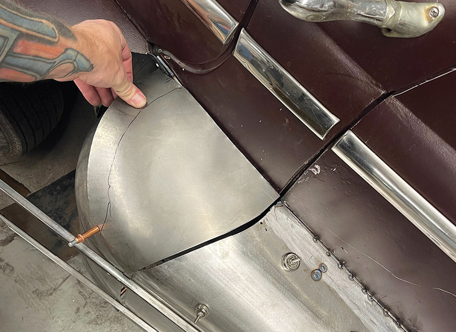 Hand positioning curved fadeaway fender panel on 1947 Ford coupe, cleco fastener, trim detail