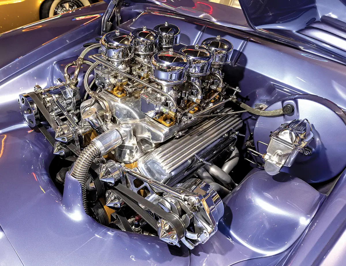 Highly customized and polished V8 engine with six chrome carburetors and a sleek metallic purple engine bay
