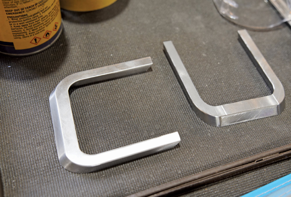 Two finished, U-shaped metal pieces