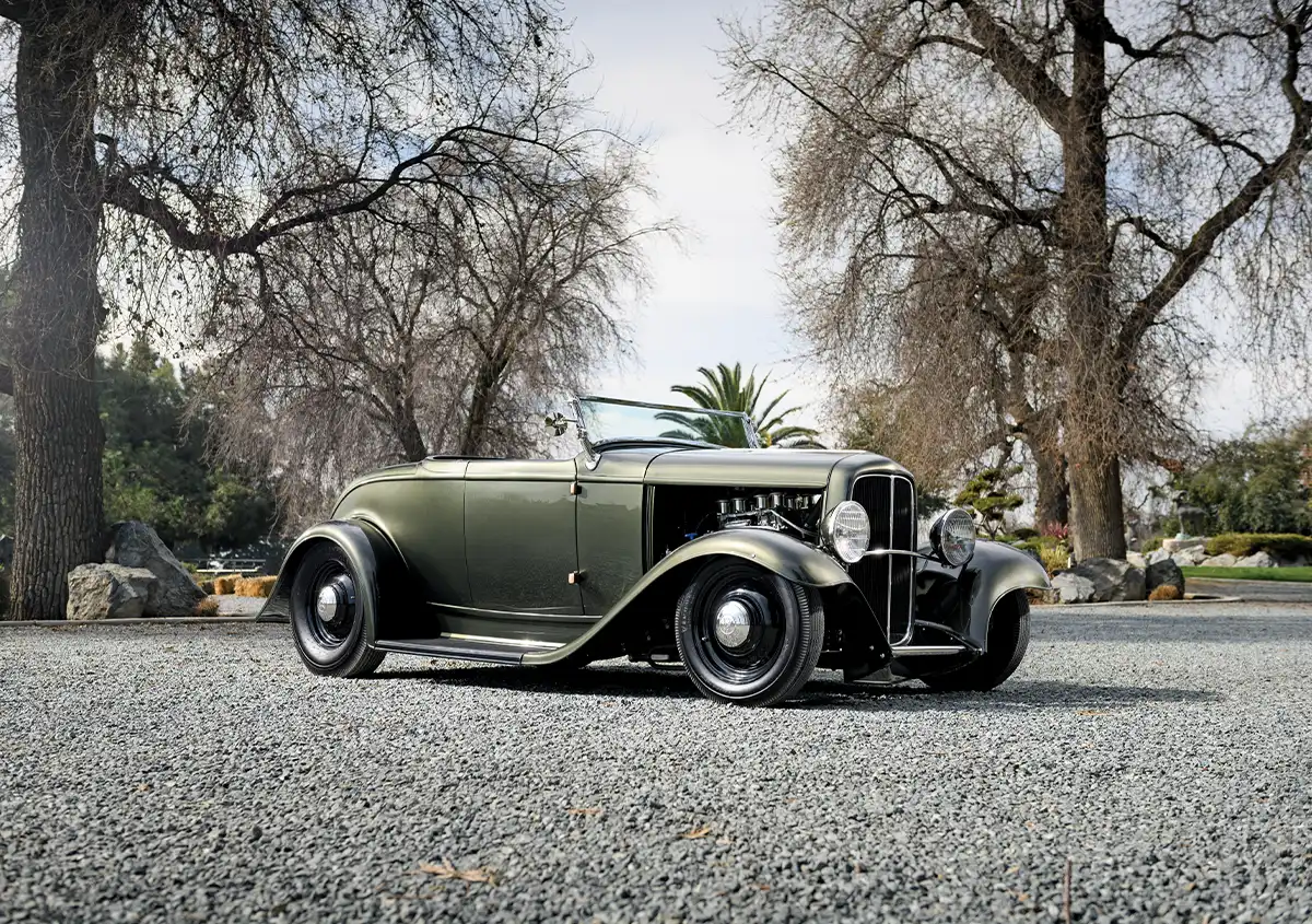 wide quarter front view of a metallic muted green 1932 Deuce Roadster