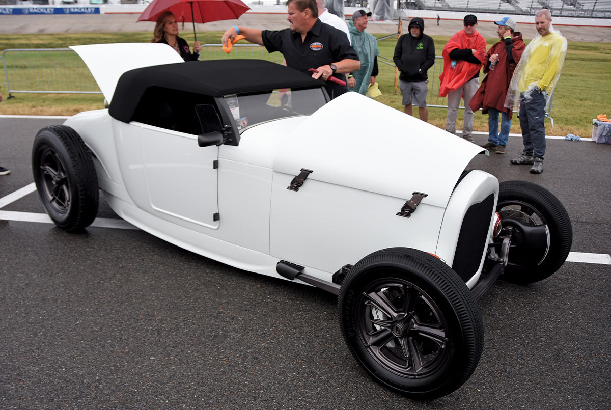 white 1927 Ford highboy roadster with a black top