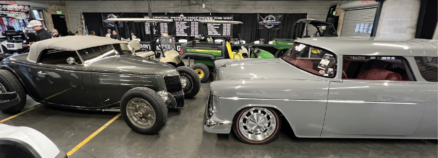 two hot rods facing each other in garage