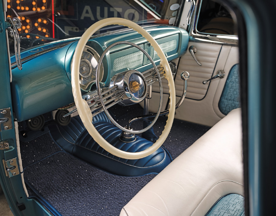 1950 Buick Special fully finished teal-and-ivory interior with factory wheel and stitched flooring