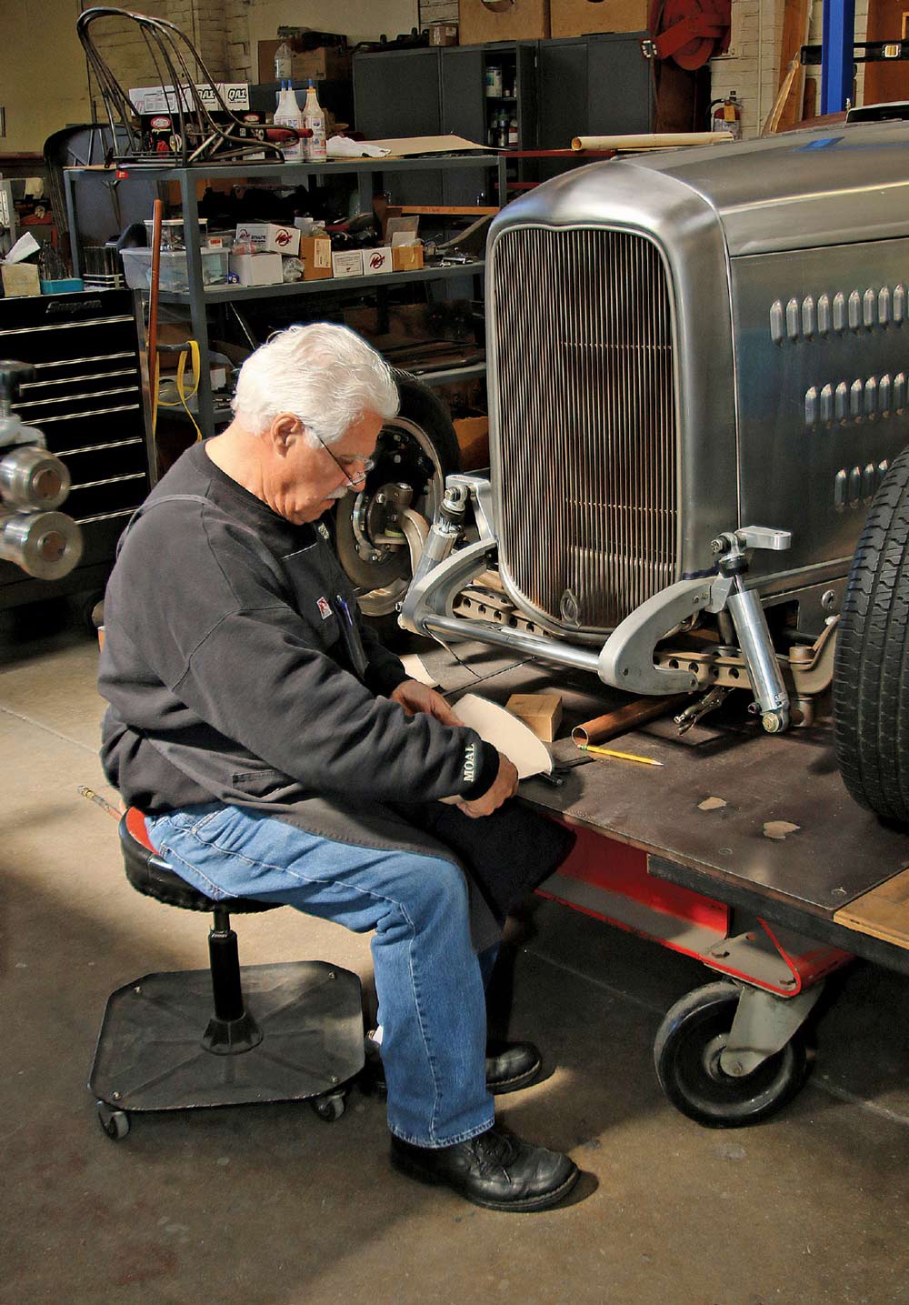 1932 Ford roadster fabrication scene showing bare-metal grille shell and suspension during shop mock-up