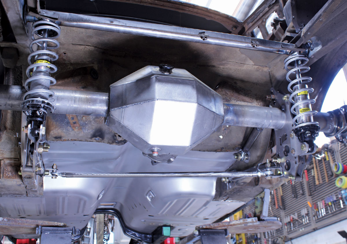 Wide view of the installed rear suspension system, featuring coilovers and a custom silver differential housing.