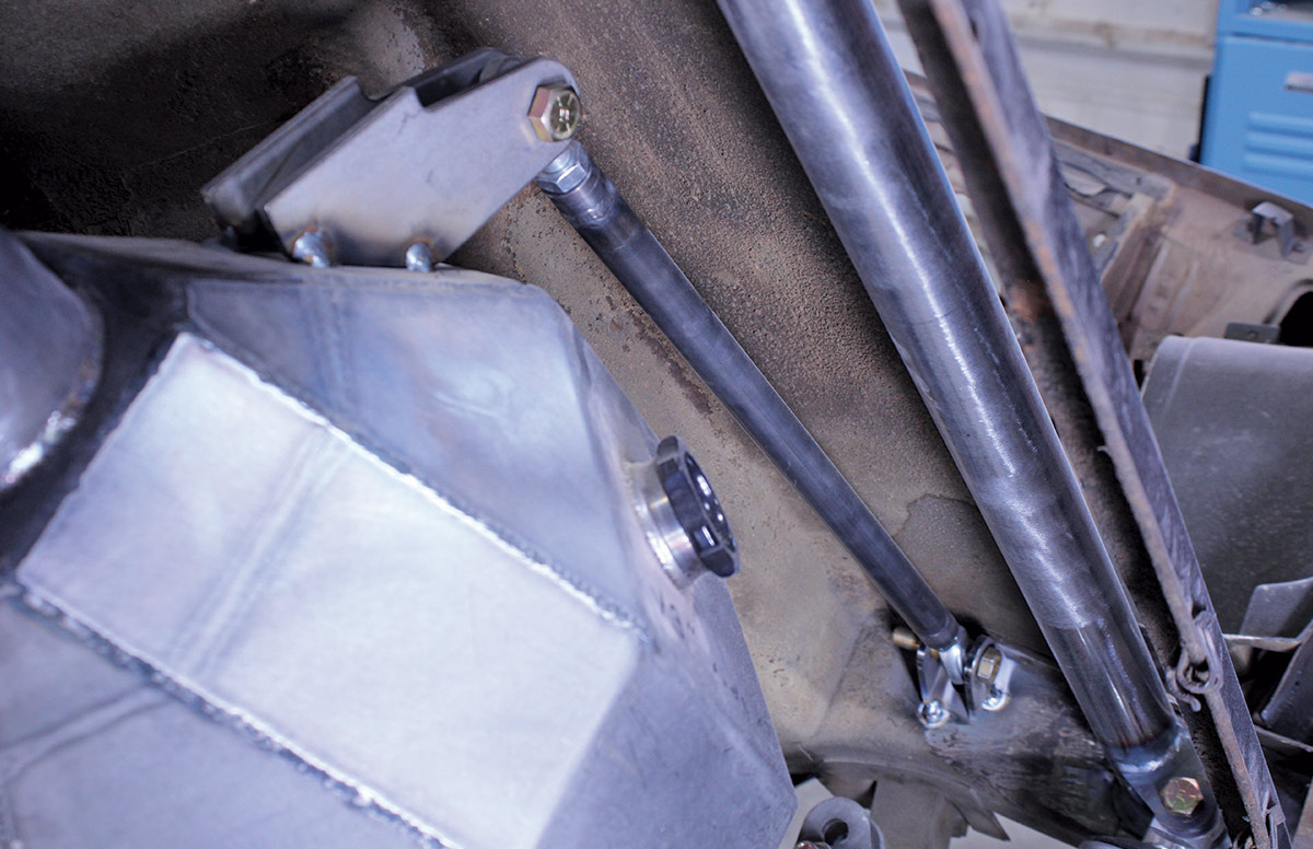 Close-up of the upper suspension mounting brackets and links attached to the custom silver differential housing.