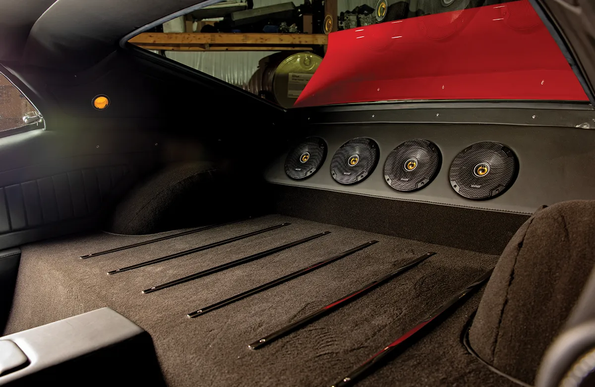 Custom-fabricated rear speaker deck with four high-performance Kicker speakers in a classic Ford Mustang trunk.