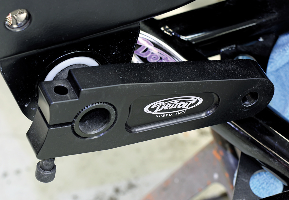Detail shot of a black "Detroit Speed" suspension arm clamped onto the splined end of a sway bar, showing the precision fit and the high-quality logo on the component.