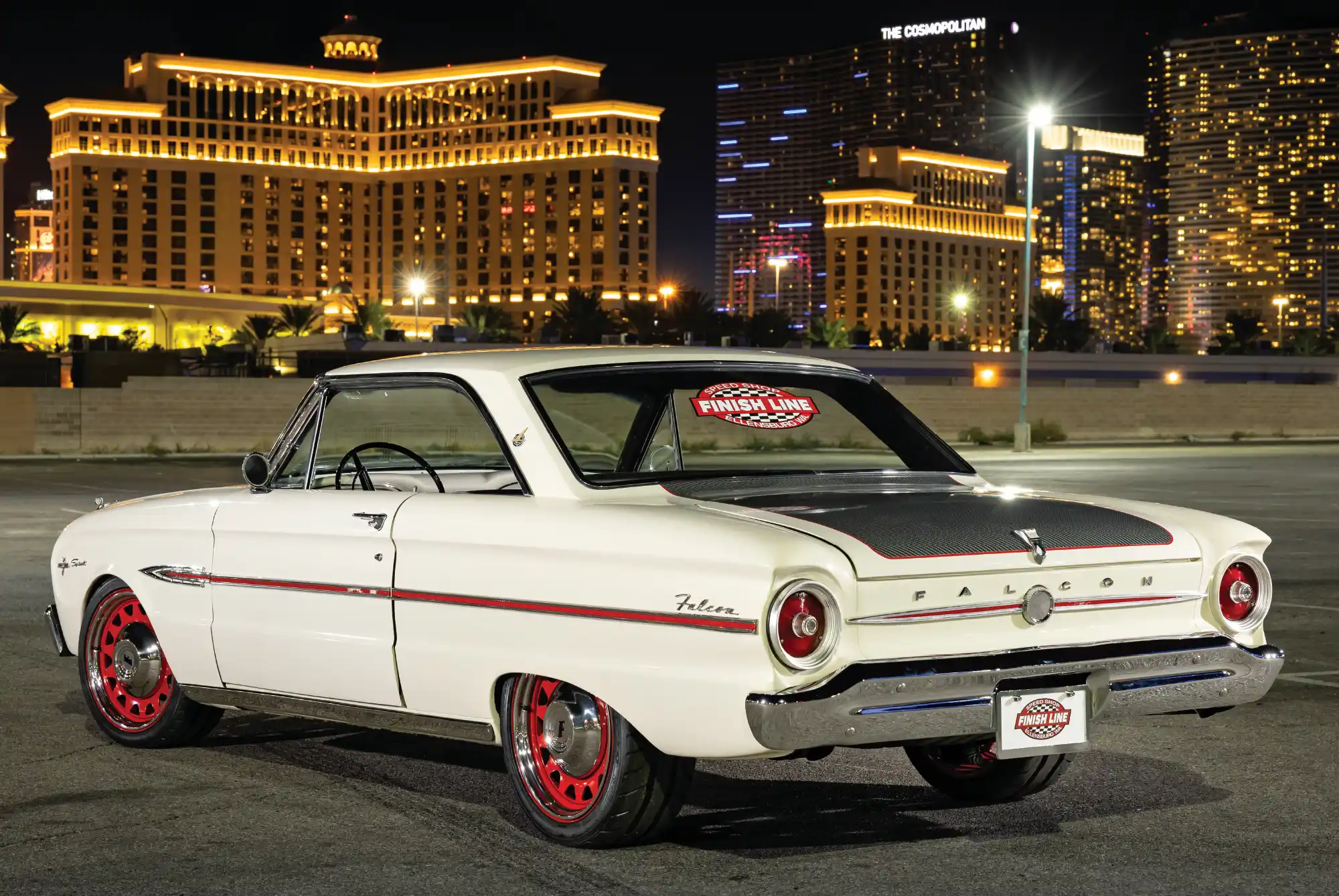 Rear perspective of a white Ford Falcon showing "Finish Line" decals on the rear window and license plate.