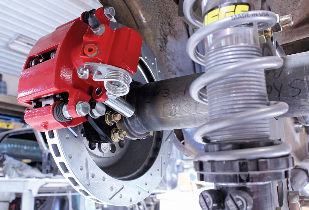 1965 mustang cpp red caliper install close-up slotted disc jegs coilover suspension rear axle