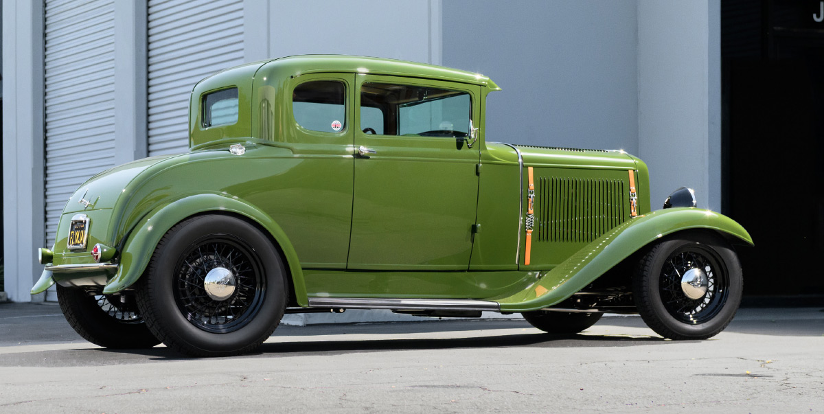 1931 ford coupe rear three quarter angle olive green hot rod outside garage black wire wheels