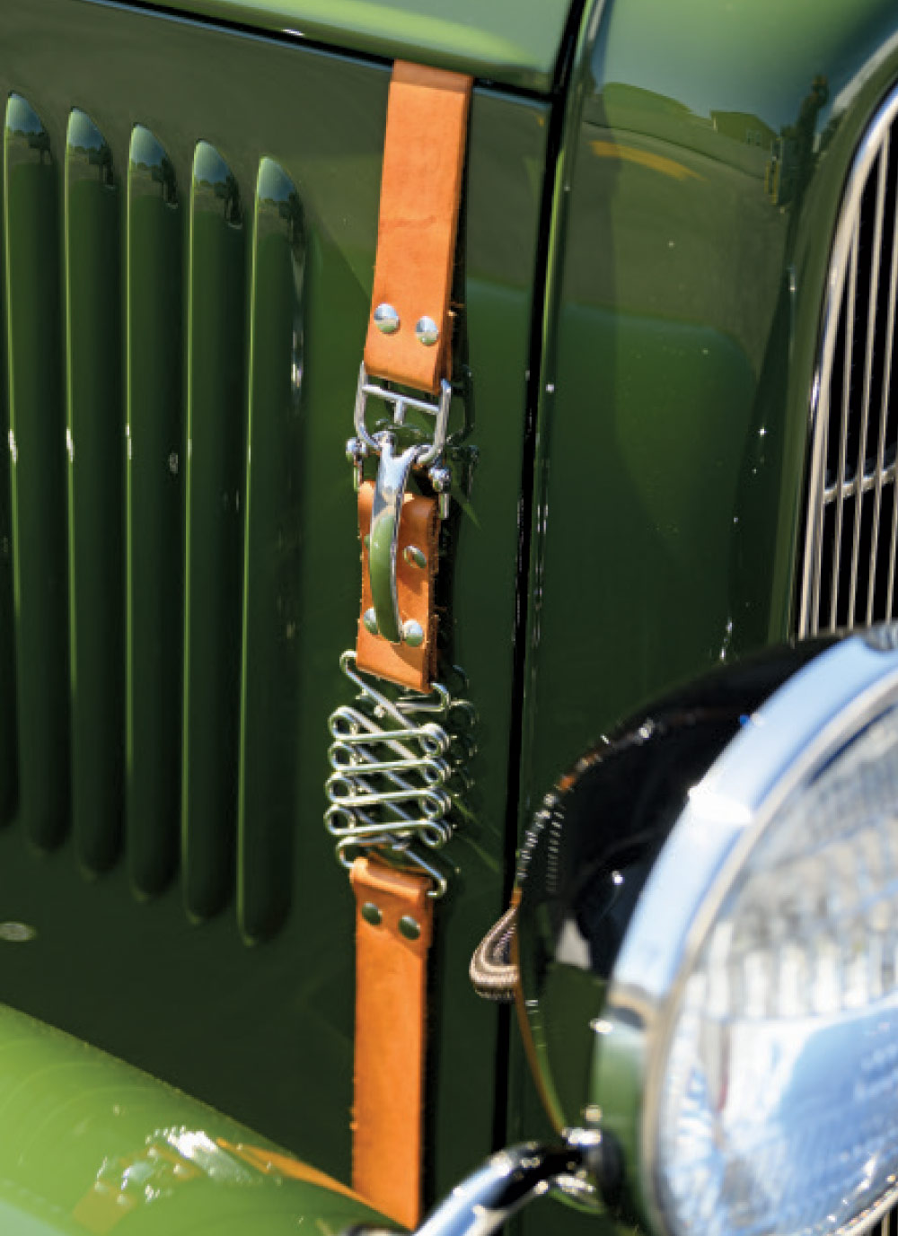 1931 ford coupe hood leather strap close-up with chrome hardware and spring latch