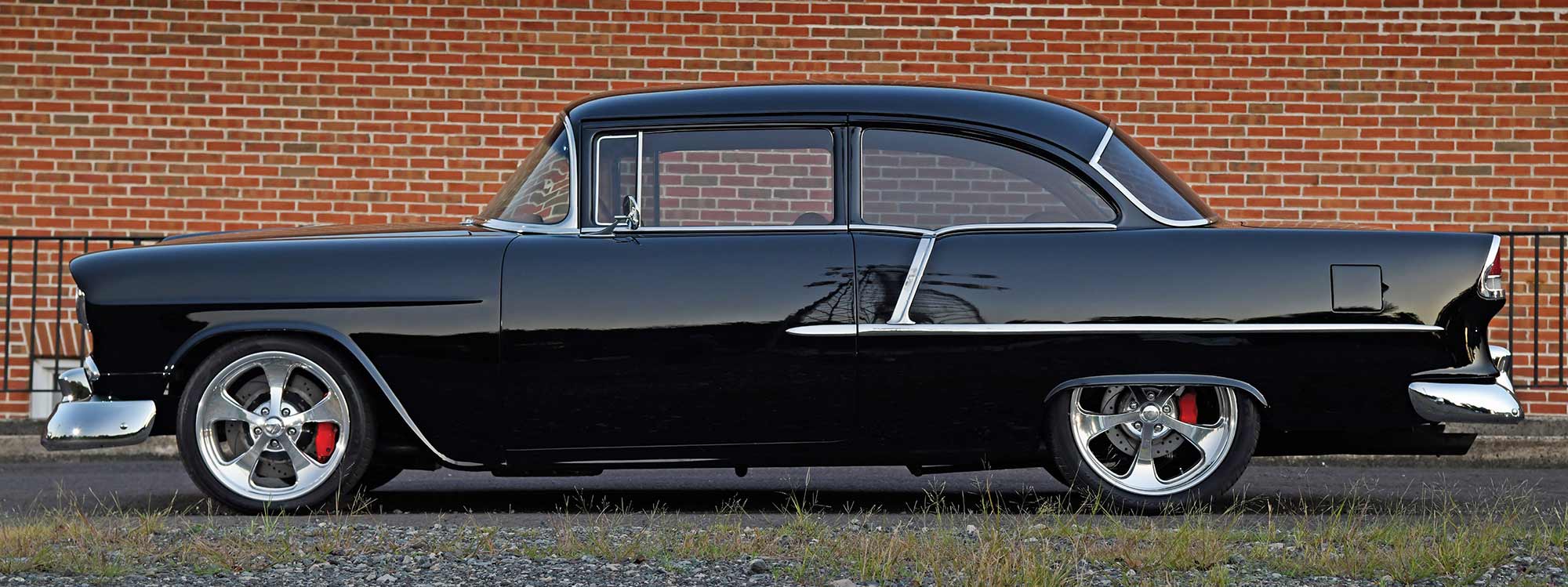Side profile showing a black 1955 Chevy
