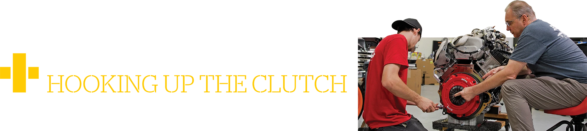 'HOOKING UP THE CLUTCH' featuring two mechanics installing a bright red clutch assembly onto an engine block in a workshop setting