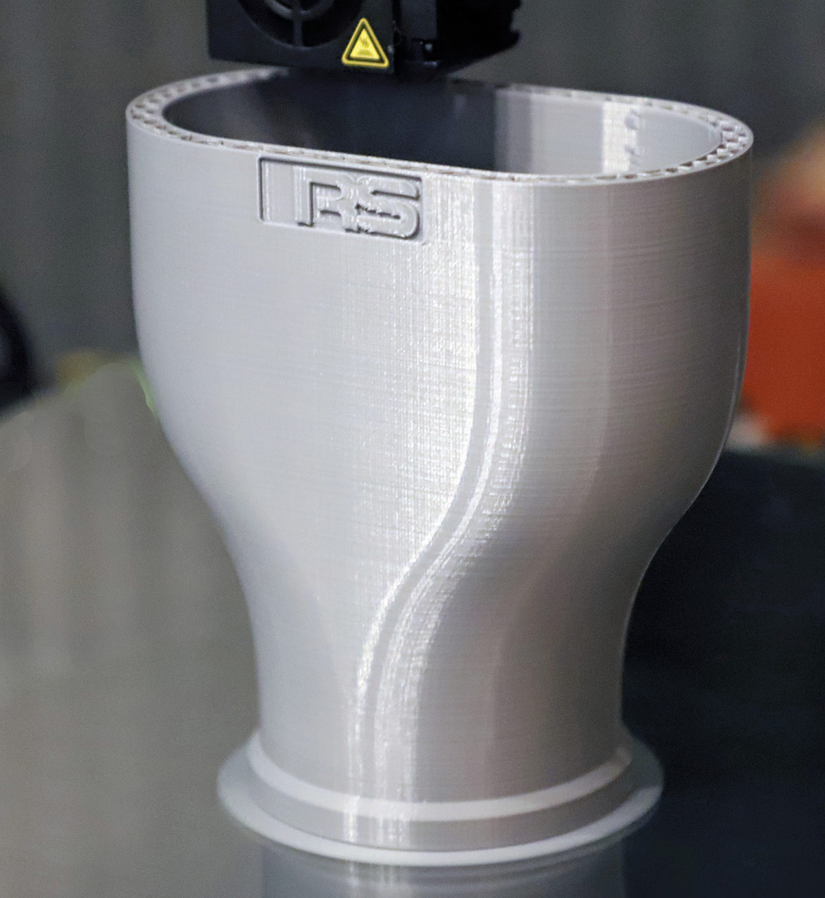 3D Printed Exhaust Tip - RS Design Close-up of a white, textured 3D printed exhaust tip