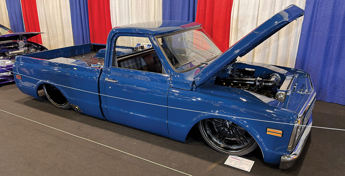 1967 Chevrolet C10 dark blue modified pickup lowered engine open hood indoor car show