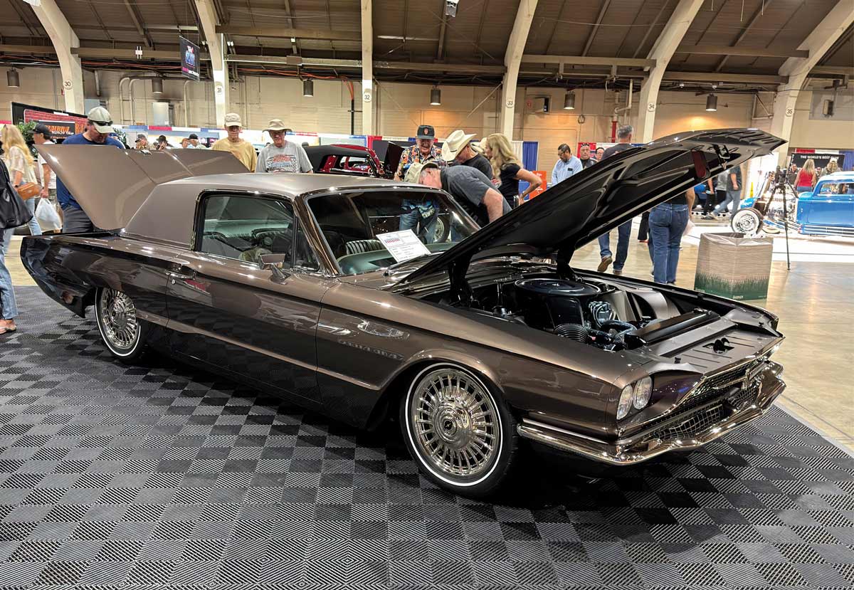 1963 Ford Thunderbird dark brown custom open hood engine car show concrete floor