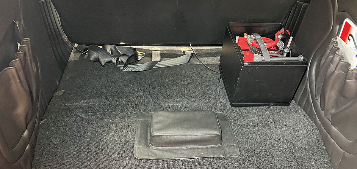 1932 Ford Roadster trunk interior with battery box and carpet ready for subwoofer enclosure installation