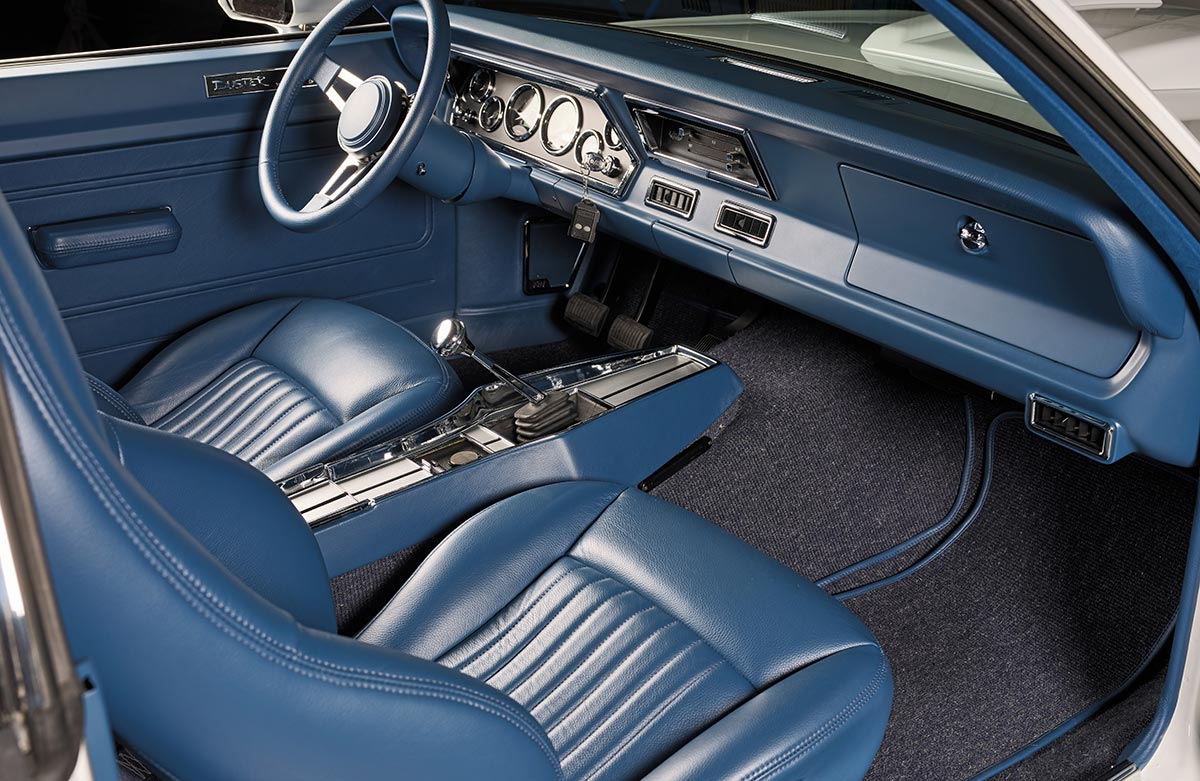 Custom blue leather bucket seats and modern dashboard interior.