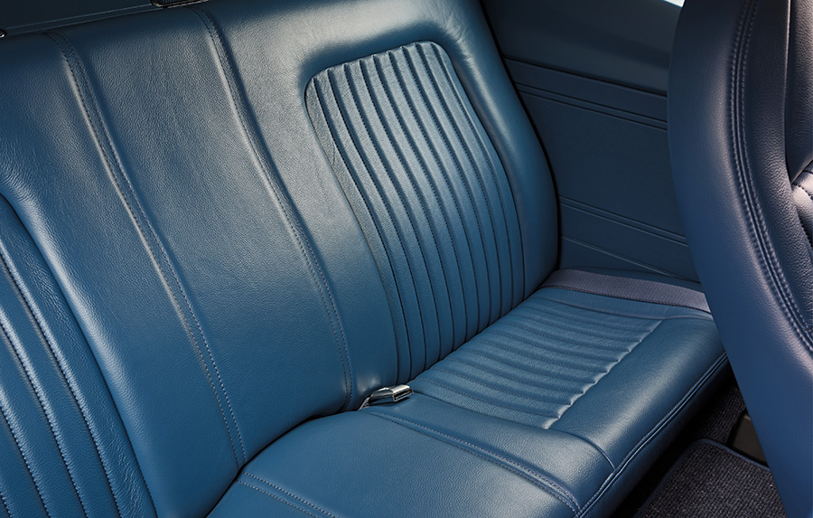 Stitching detail on the blue leather rear bench seat.