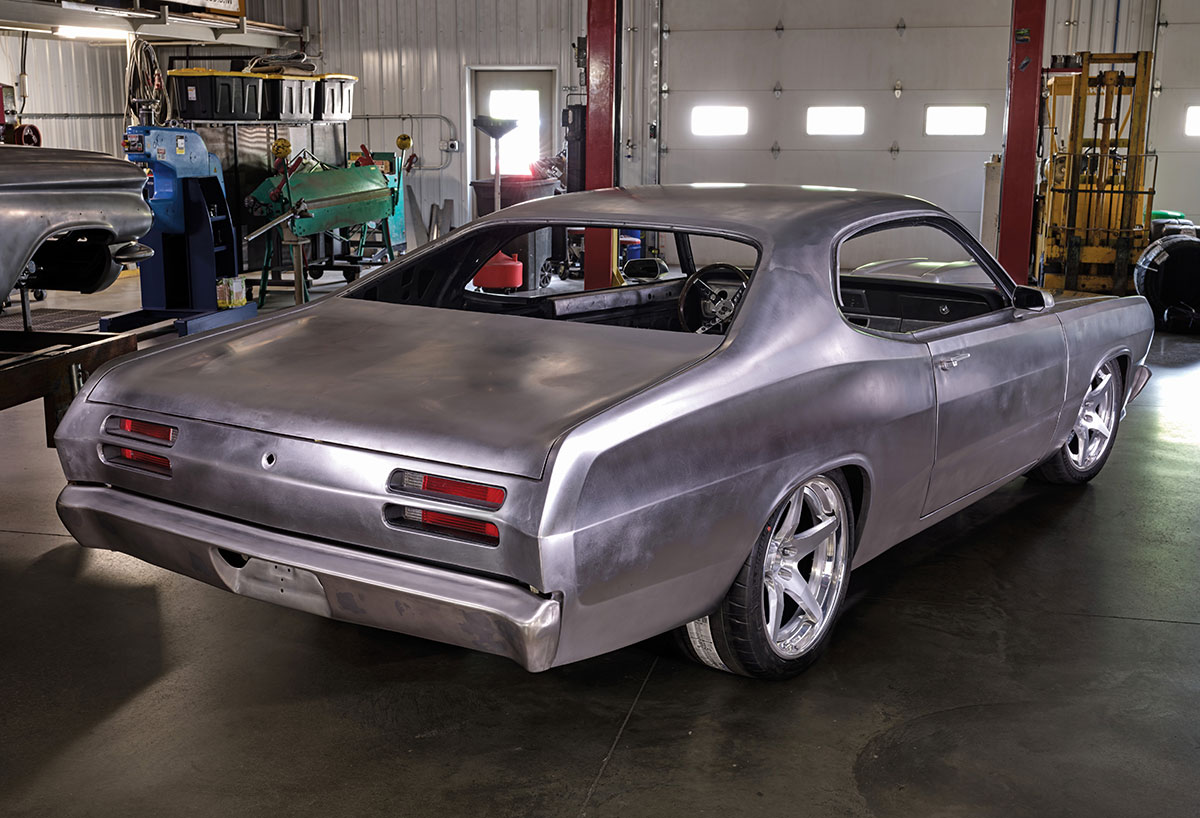 Rear corner view of the Duster in bare metal state.