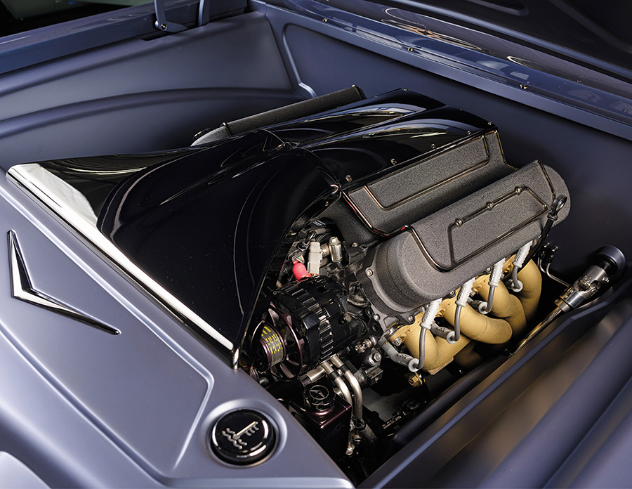 Clean engine bay with custom covers and high-performance components.