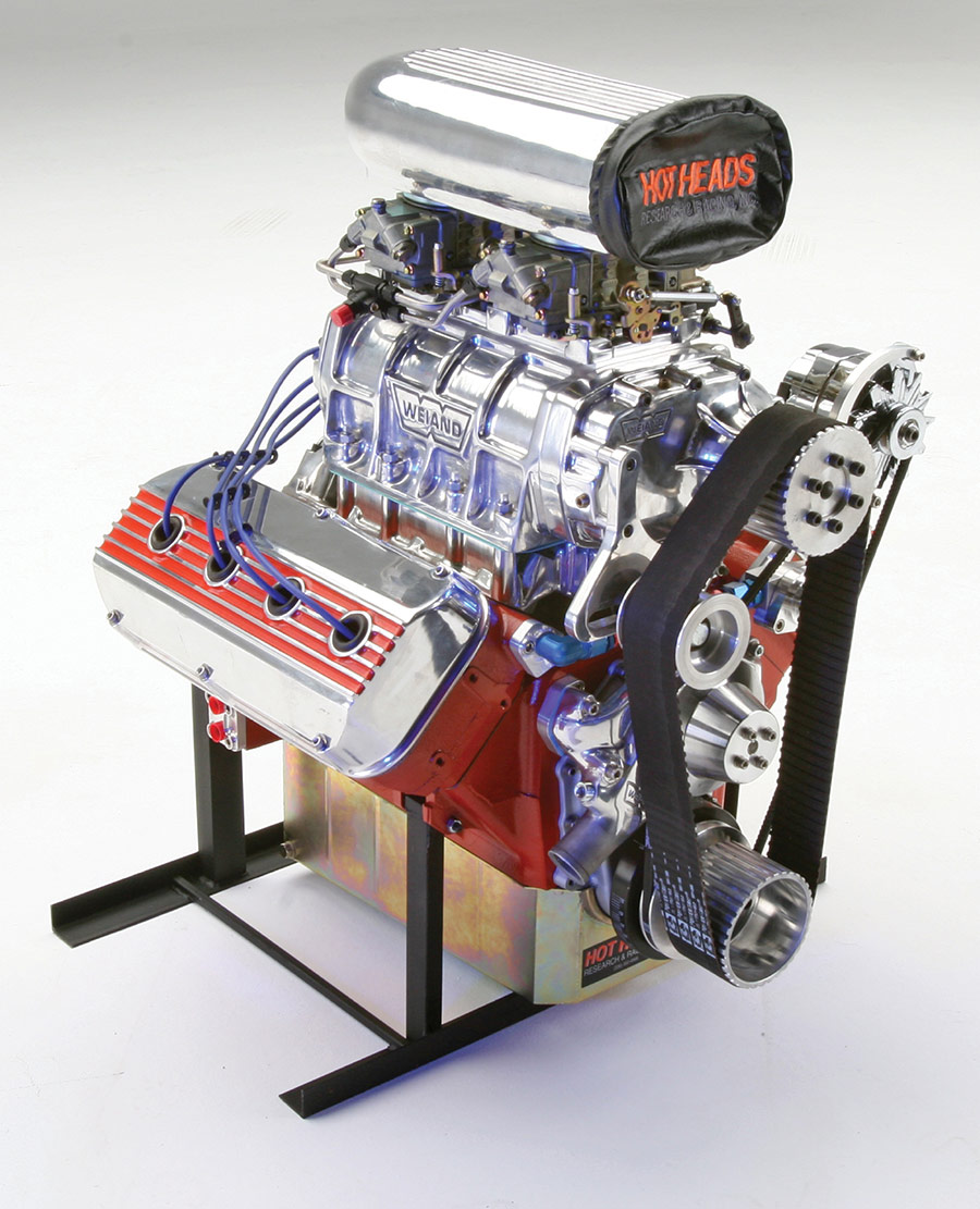 Polished 392 Hemi engine with blower on a stand.