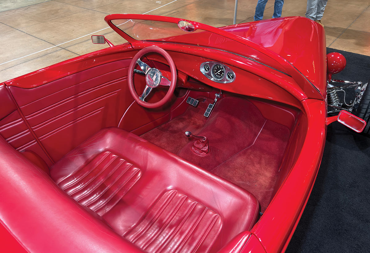 Top-down view of the monochromatic red leather interior and steering wheel.