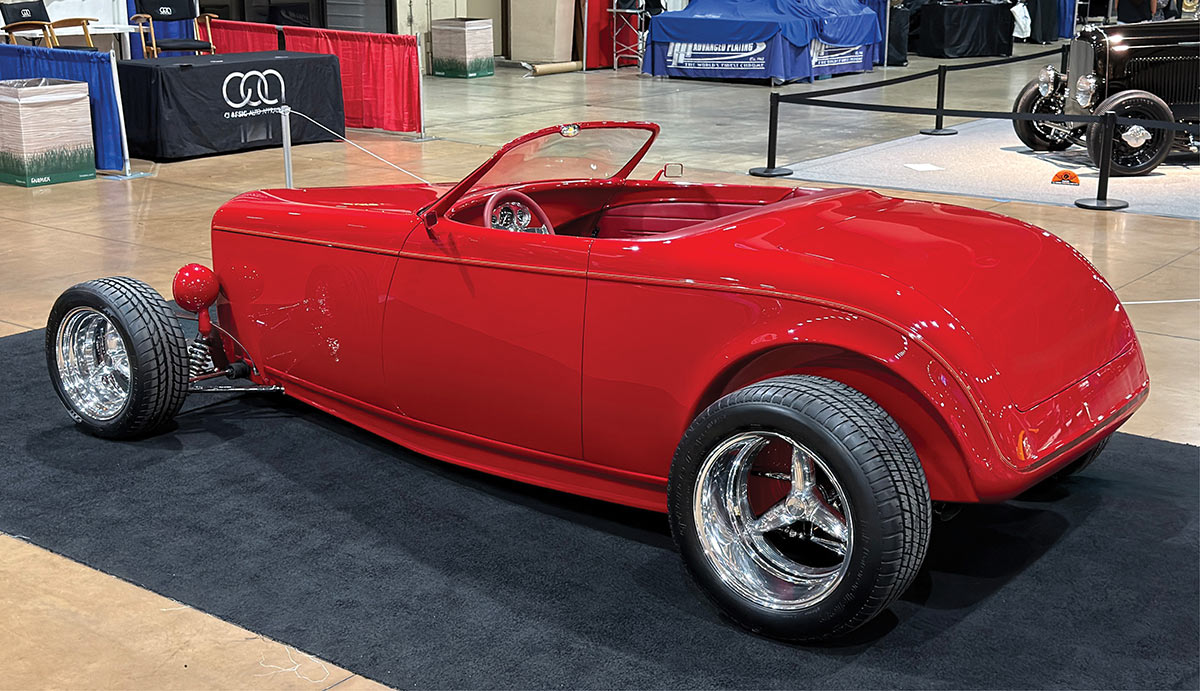 Rear three-quarter view showing the smooth body lines and chrome wheels.