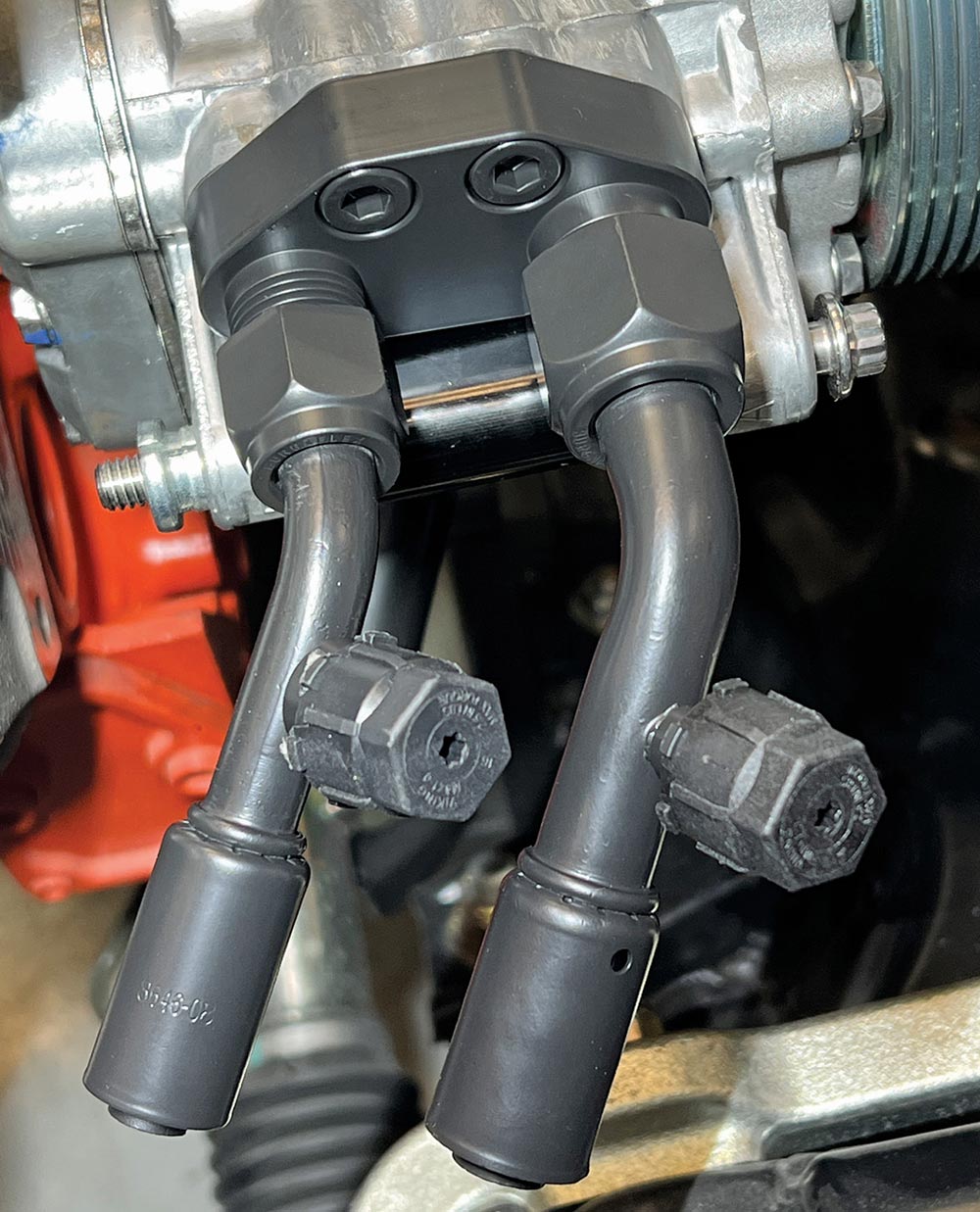 Beadlock fittings with service ports on AC compressor.