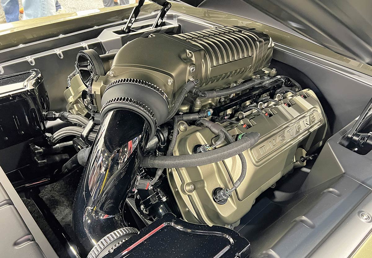 intercooled Magnuson supercharged Coyote V-8 in a fully hand-formed aluminum bay
