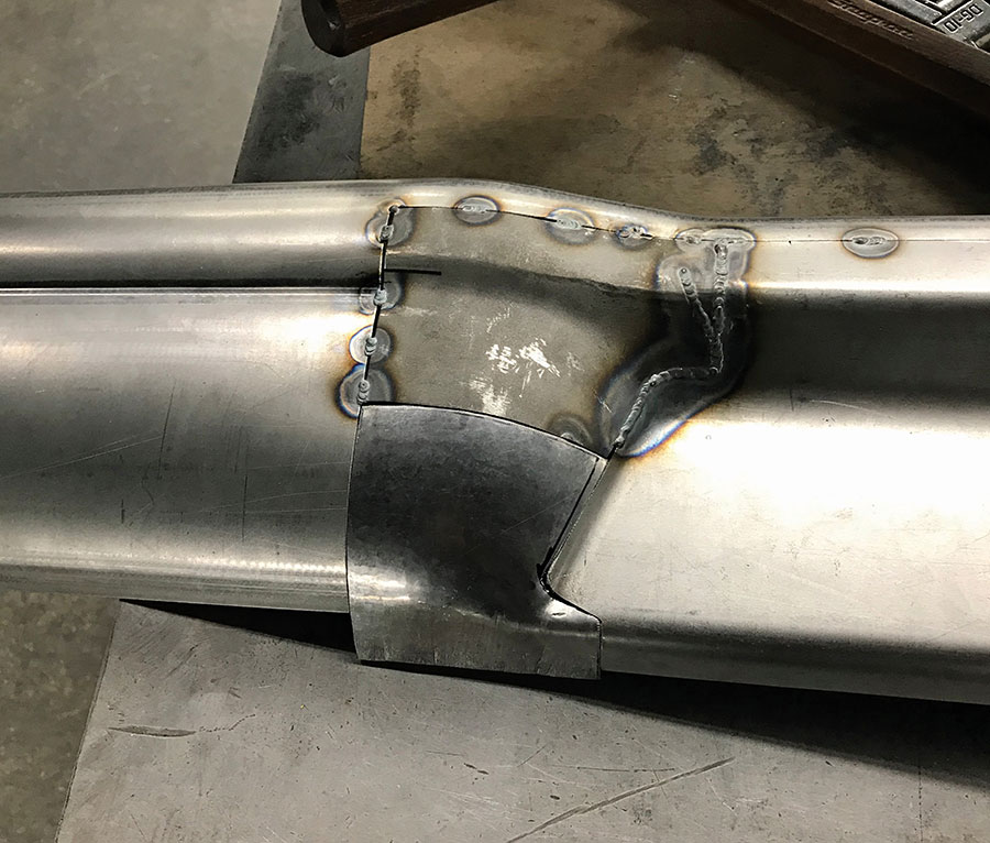 Fabricated metal piece fitted to original bumper