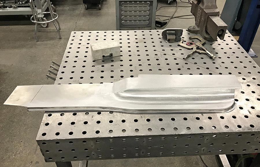 Sanded weld seam on a metal panel